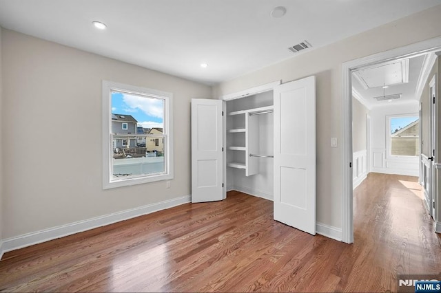 unfurnished bedroom with wood-type flooring and a closet