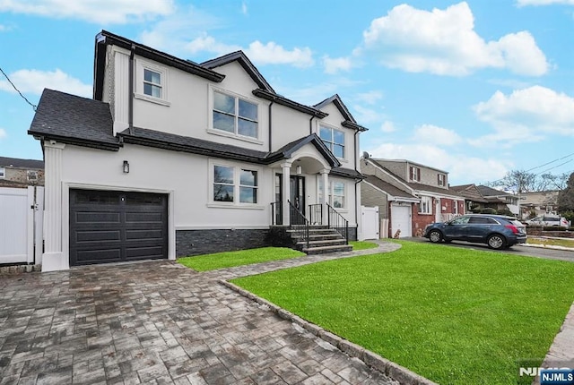 view of front of house with a garage and a front yard