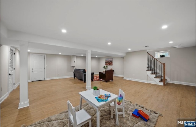 rec room with light hardwood / wood-style floors and ornate columns