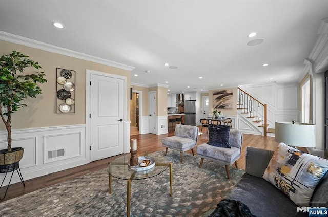 living room featuring ornamental molding and dark hardwood / wood-style floors