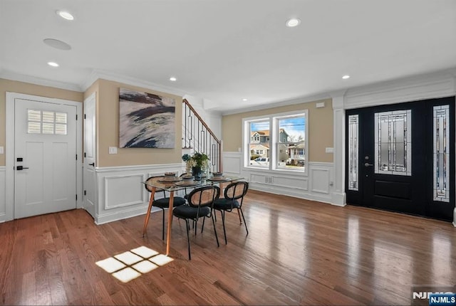 entrance foyer featuring hardwood / wood-style flooring and ornamental molding