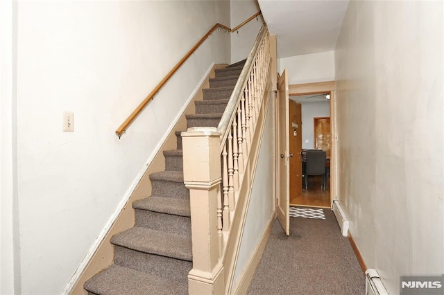 staircase featuring carpet floors and a baseboard heating unit