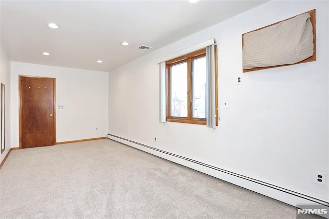 empty room with light carpet and baseboard heating