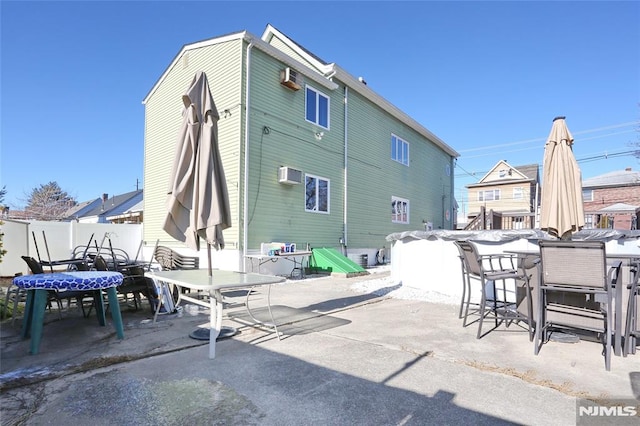 view of patio with a wall mounted AC