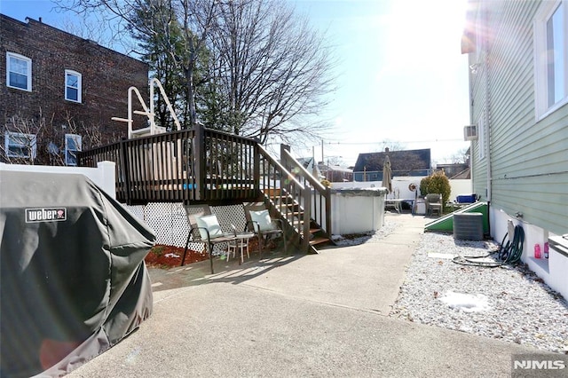 exterior space with central AC unit and a deck