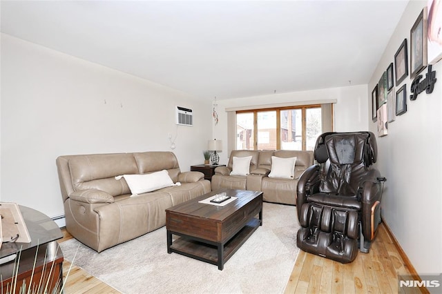 living room featuring light hardwood / wood-style floors and a wall unit AC