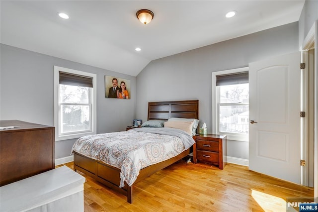 bedroom featuring lofted ceiling and light hardwood / wood-style flooring