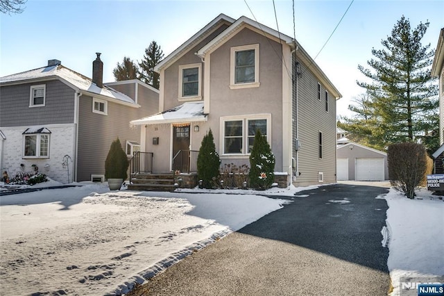 front of property with a garage and an outdoor structure