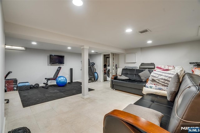 exercise room featuring washer / dryer