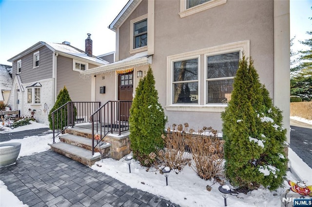 view of snow covered property entrance