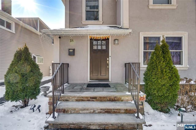 view of snow covered property entrance