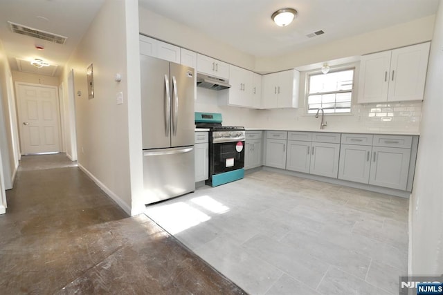 kitchen with gray cabinetry, sink, tasteful backsplash, and appliances with stainless steel finishes