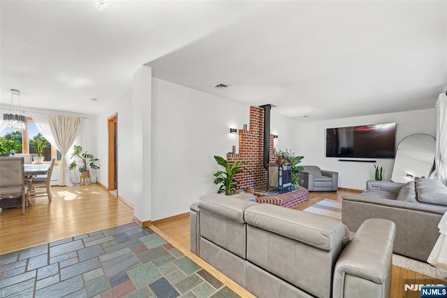 living room with hardwood / wood-style flooring and a wood stove