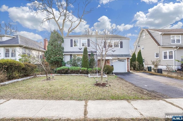 front of property with a garage and a front yard