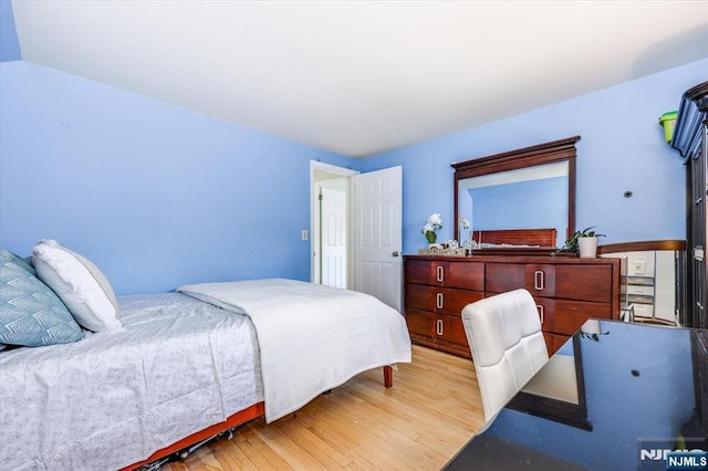 bedroom with light hardwood / wood-style flooring and vaulted ceiling