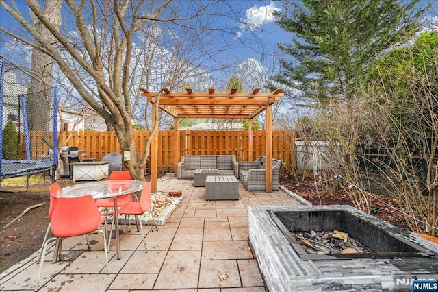 view of patio featuring a pergola, a trampoline, and an outdoor living space with a fire pit