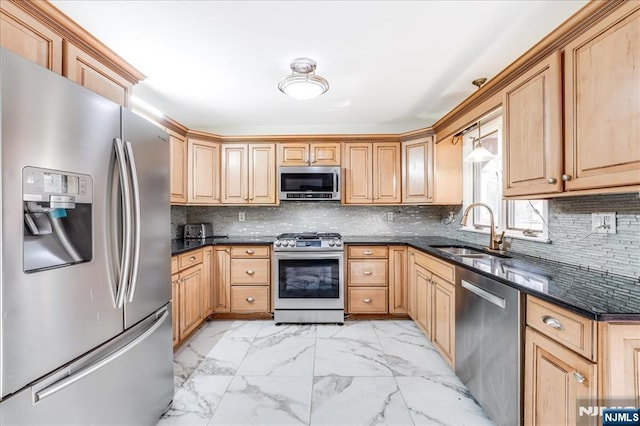 kitchen with sink, appliances with stainless steel finishes, hanging light fixtures, decorative backsplash, and dark stone counters