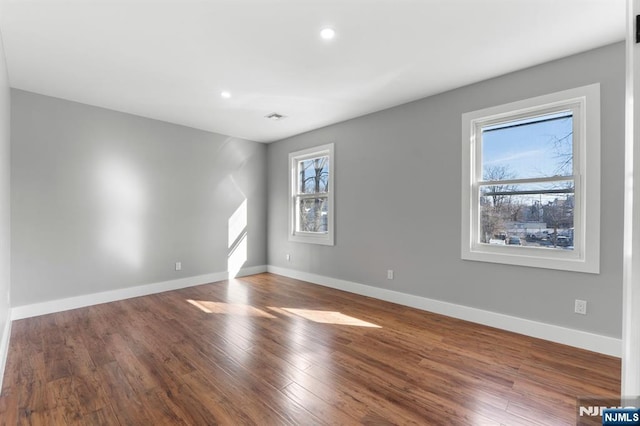 unfurnished room featuring hardwood / wood-style flooring