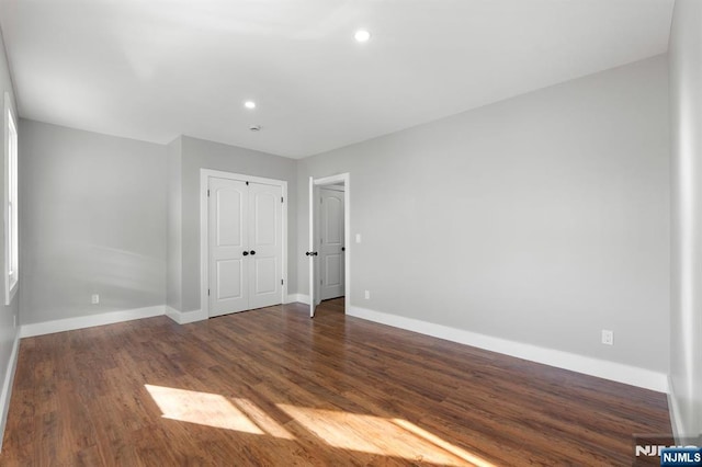 spare room with dark hardwood / wood-style floors