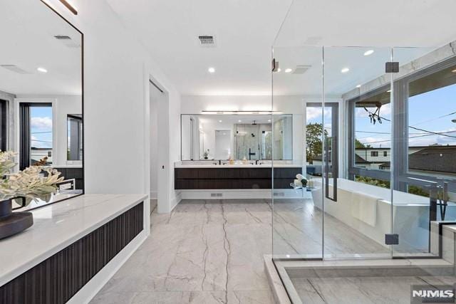 bathroom with vanity and plus walk in shower