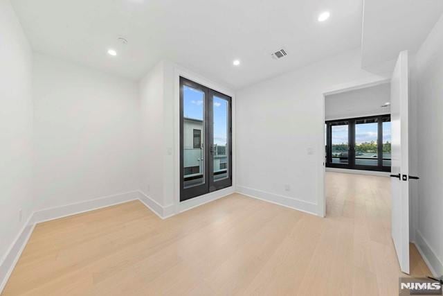 unfurnished room featuring light hardwood / wood-style floors