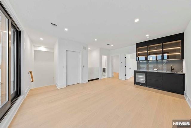 kitchen featuring sink, a wealth of natural light, and light wood-type flooring