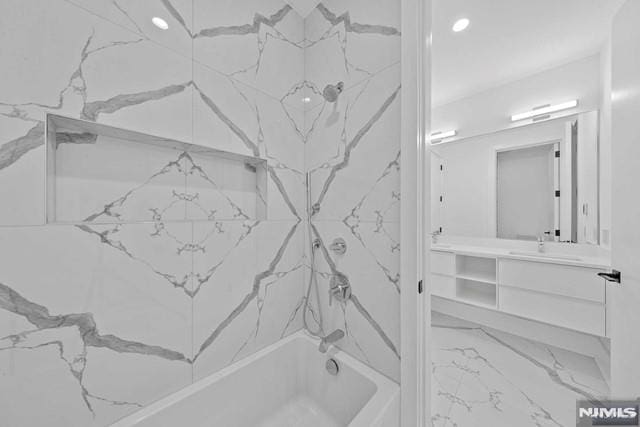 bathroom featuring vanity and tiled shower / bath combo