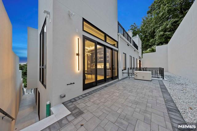 property exterior at dusk featuring a patio