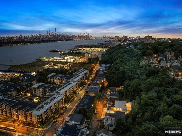 aerial view at dusk with a water view