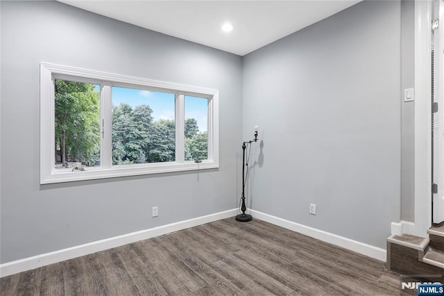 unfurnished room featuring hardwood / wood-style flooring