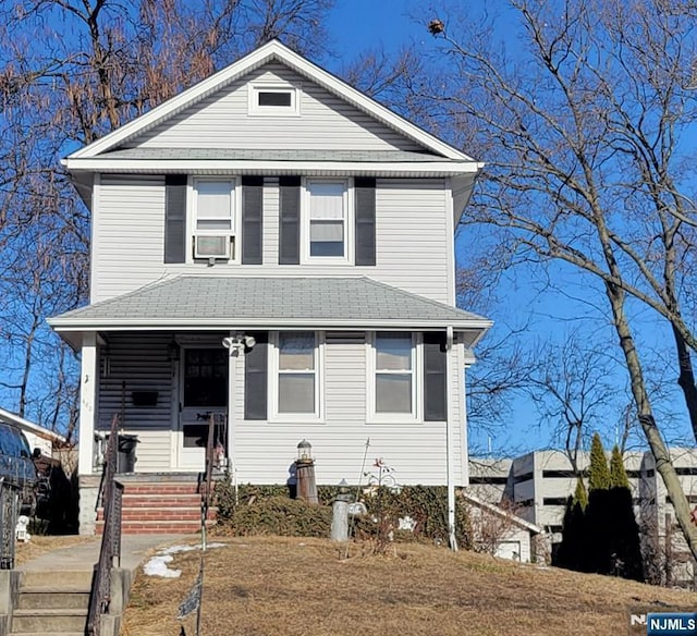 view of front of property featuring cooling unit and a porch