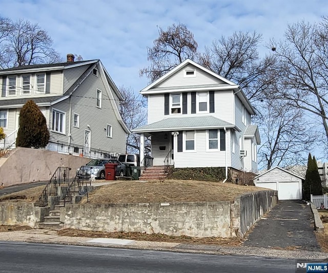 view of property with an outbuilding and a garage