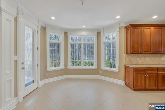 unfurnished dining area featuring light tile patterned floors