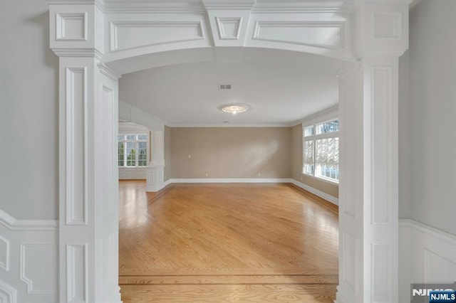 empty room with crown molding and wood-type flooring