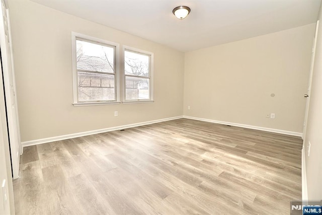 spare room with light wood-type flooring