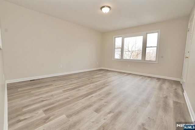 spare room featuring light hardwood / wood-style flooring