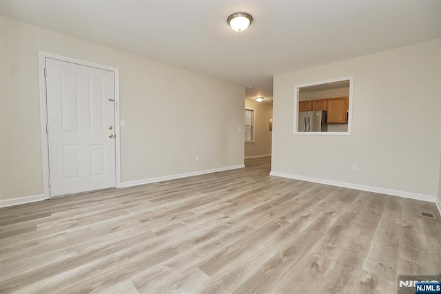 spare room with light hardwood / wood-style flooring