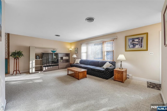 living room with a baseboard heating unit and carpet