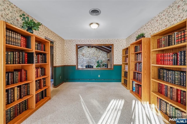 living area featuring light colored carpet and baseboard heating