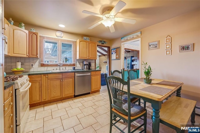 kitchen featuring stainless steel dishwasher, sink, white gas stove, and backsplash