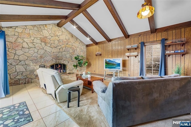 living room with lofted ceiling with beams, a stone fireplace, and wood walls