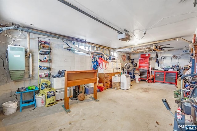 garage with a garage door opener and a workshop area