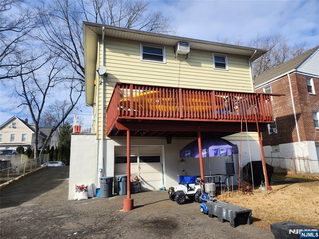 back of house with a wooden deck