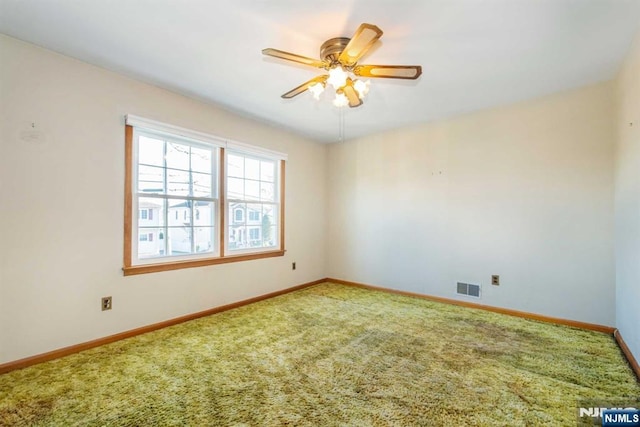 carpeted empty room featuring ceiling fan