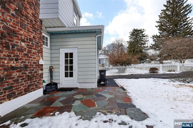 view of snow covered exterior featuring a patio