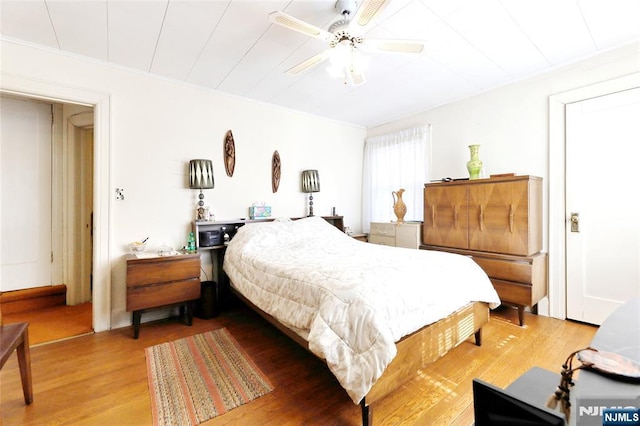 bedroom with wood-type flooring and ceiling fan