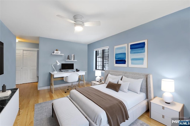 bedroom featuring ceiling fan and light hardwood / wood-style flooring