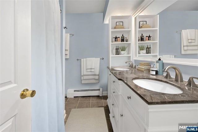 bathroom with vanity, a baseboard heating unit, and tile patterned flooring