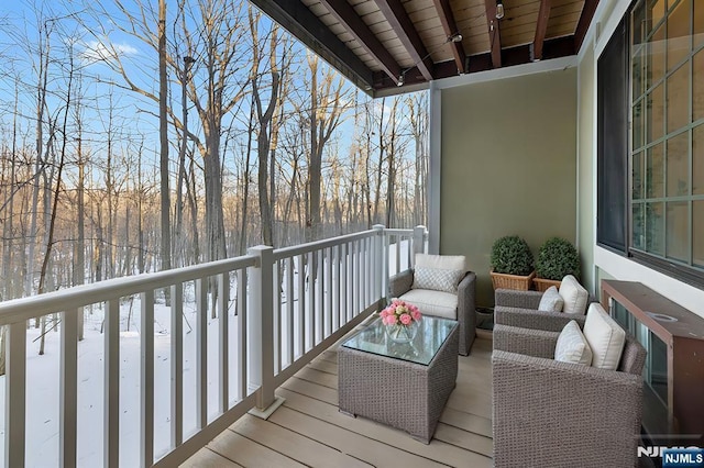 view of snow covered back of property