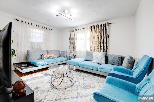 living room with wood-type flooring and a chandelier